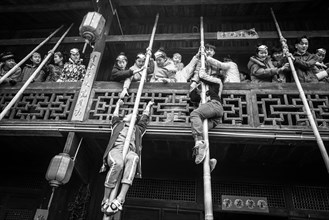 Young people preparing a production in which they rob unmarried woman from a balcony
