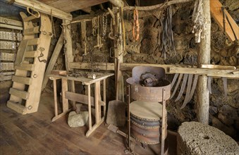 Interior view of a historical workshop with grindstone on a peat farm