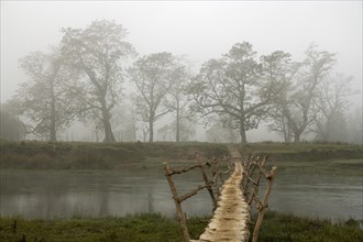 Bridge in the morning mist over the Rapti River