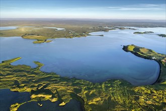 Aerial view of coast with green pseudo-craters