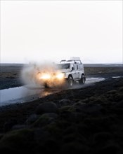 White Land Rover in action with splashing water