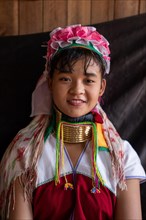 Young long necked woman with several brass rings around her neck