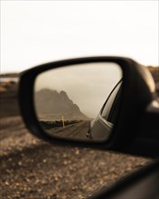 Vestrahorn mountain in the side mirror of Auto