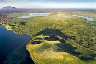 Aerial view of coast with green pseudo-craters