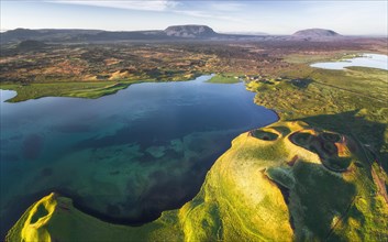 Aerial view of coast with green pseudo-craters