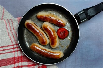 Chipolata sausages in pan