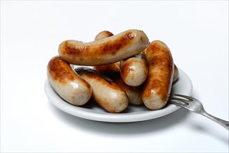 Chipolata sausages on plate