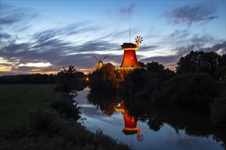 Illuminated Greetsiel twin mills at sunset