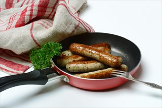 Nuremberger Rostbratwurstchen in pan