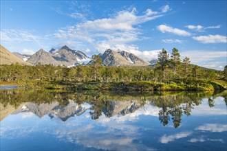Mountains of the Lyngen Alps are reflected in the lake