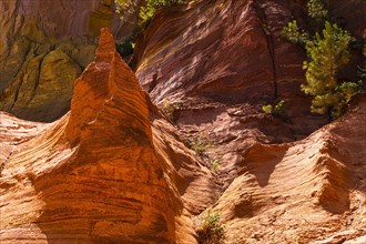 Red shining pointed rock in the natural park of ochre rocks in Roussillon