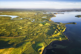 Aerial view of coast with green pseudo-craters