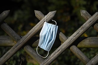 Lost face mask hangs on hunter's fence