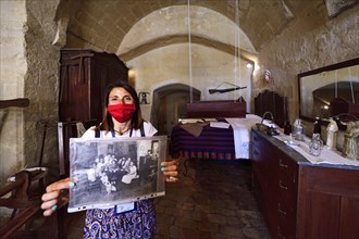 City guide shows old photographs at the Casa Grotta Museum