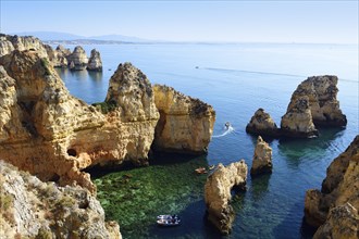 Excursion boats and SUP boarders in the bay of Ponta da Piedade