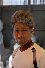 Man with white rock dust on face