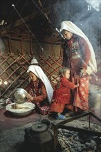 Two woman and a child in traditional Kyrgyz traditional traditional traditional traditional traditional traditional traditional traditional traditional costume