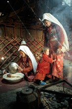 Two woman and a child in traditional Kyrgyz traditional traditional traditional traditional traditional traditional traditional traditional traditional costume
