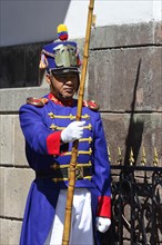 Guard in colourful uniform in front of the seat of government Palacio de Carondelet