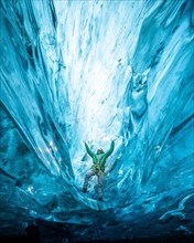 Person in an ice cave with headlamp