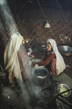 Two woman stirring dough for flat bread
