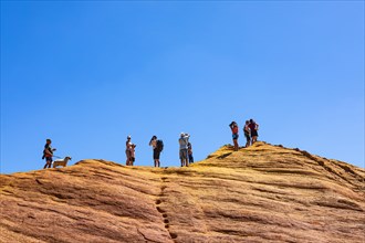 Tourists on the top of an ochre cliff