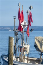 Fishing boat with red flags
