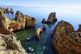 Excursion boats and SUP boarders in the bay of Ponta da Piedade
