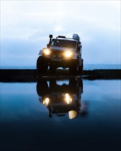 White Land Rover Jeep with reflection in the Blue Hour