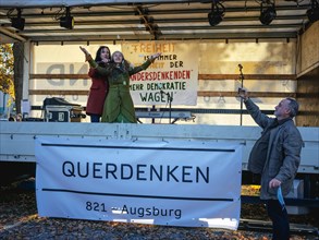 A speaker throws rose petals at a demonstration against corona measures of the Querdenken-Buendnis on 14.11.2020 in Schrobenhausener Strasse