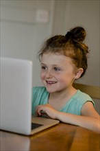 Child sitting at the laptop