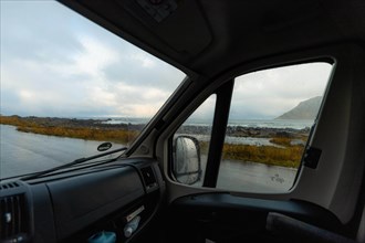 View from a rainy campervan window on Flakstad beach