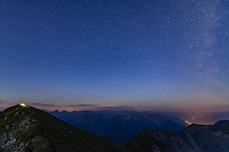 Starry sky summit of Kreuzspitze and tent