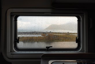 View from rainy campervan kitchen window on Flakstad beach