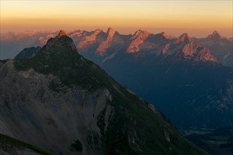 Summit of the Pfeilspitze in the foreground and Hornbachkette in the background at sunrise
