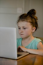 Child sitting at the laptop