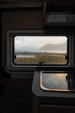 View from rainy campervan kitchen window on Flakstad beach