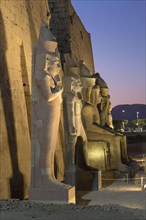 Temple of Luxor at dusk with colossal statues of Ramses ll