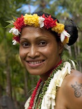 Young smiling local woman with traditional flower decoration