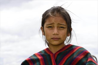 Indigenous girl looks seriously into the camera