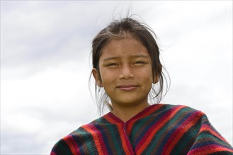 Indigenous girl looks smiling into the camera