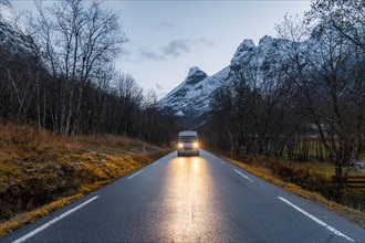 Campervan with bright lights on road near Trollstigen