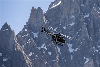 Helicopter in front of mountains