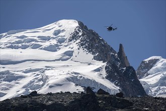 Helicopter flies over glaciers