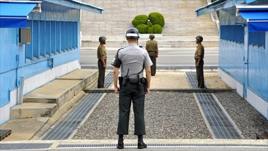 Soldiers standing at the blue barracks in the demilitarized zone