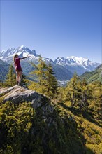 Hiker pointing at mountain panorama