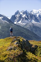 Hiker looking at mountain panorama from Aiguillette des Posettes
