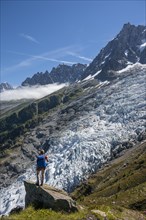 Hiker in front of glacier tongue