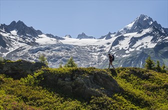 Hiker walking in front of mountain panorama from Aiguillette des Posettes