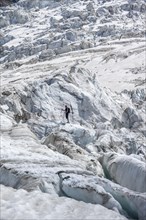 Climber standing on rifted glacier